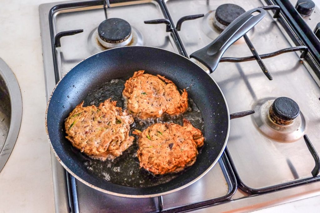 frying fritters in pan of oil zucchini fritters recipe