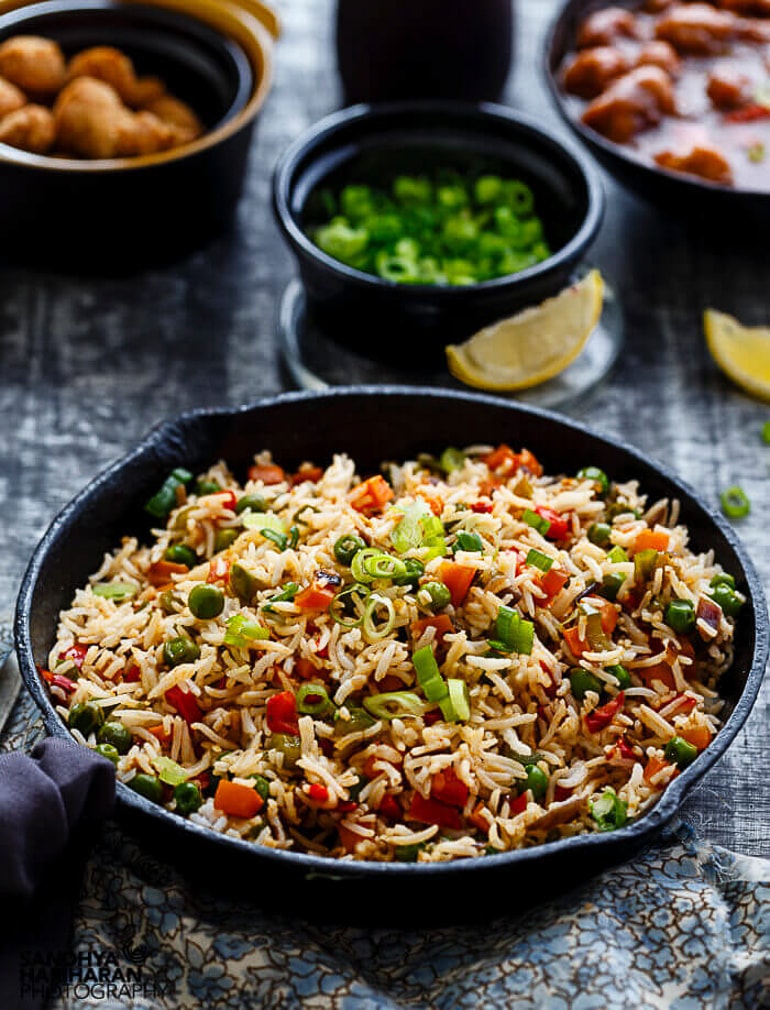 large pan of fried rice on table with other bowls healthy meals
