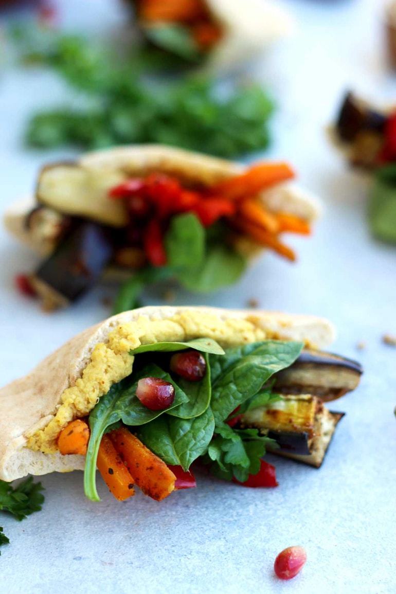 Cut up pita stuffed with hummus, spinach and grilled vegetables