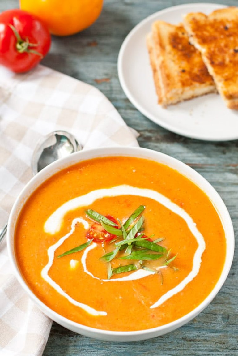 Creamy Tomato Soup With Tomato Basil Garnish in white bowl