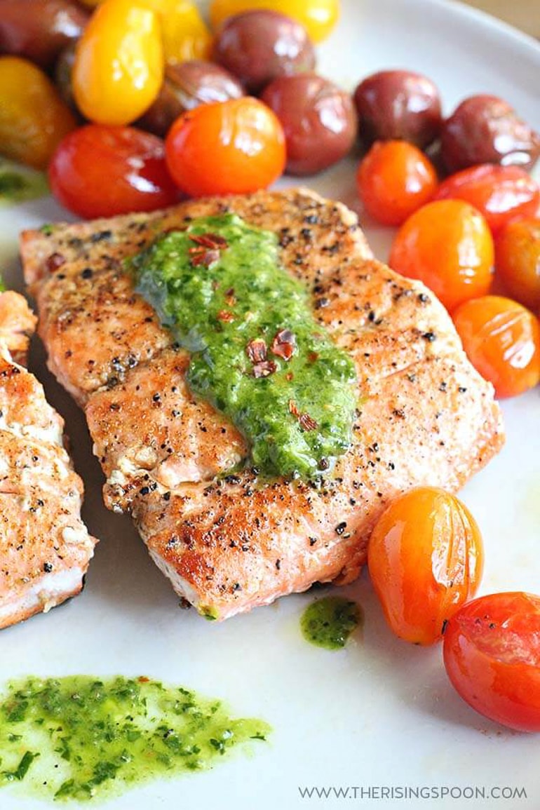 seared salmon steaks on plate with cherry tomatoes
