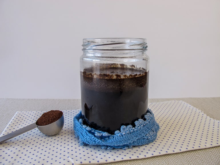 clear jar of cold brew coffee in table with spoon