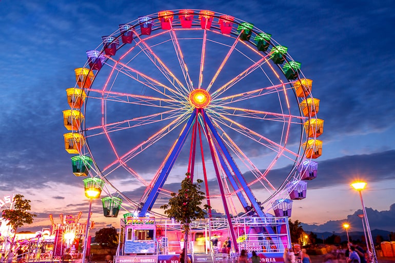 Colorful ferris wheel with dark blue sky in background