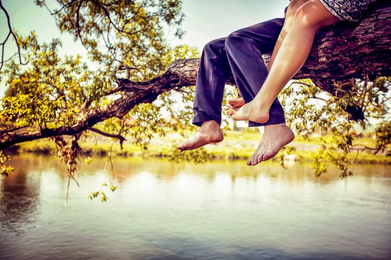 legs dangling off tree branch over water dating an introvert