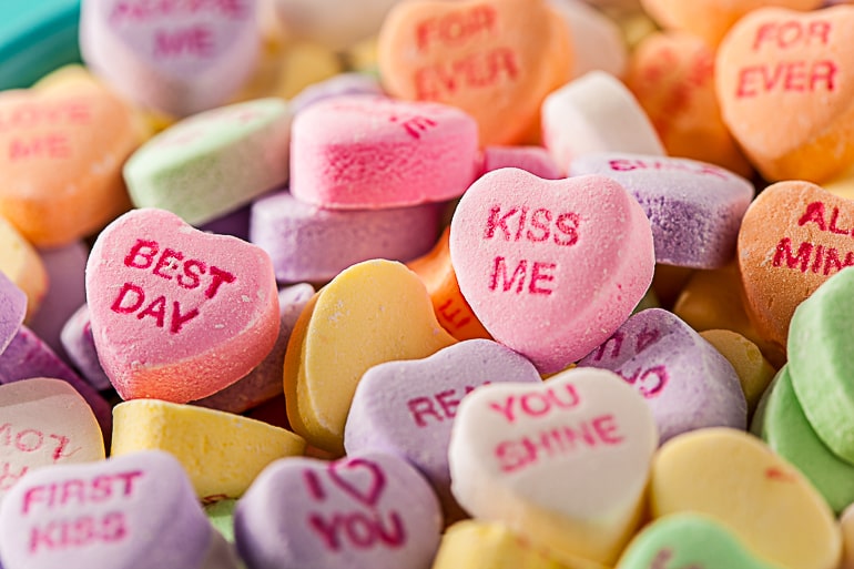 Closeup of small colorful candy hearts with words on it