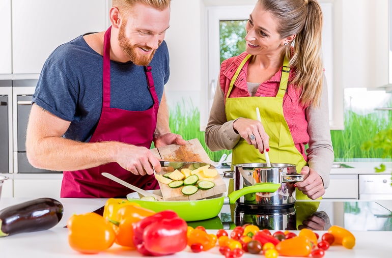 man and woman wearing aprons cooking together good first date ideas