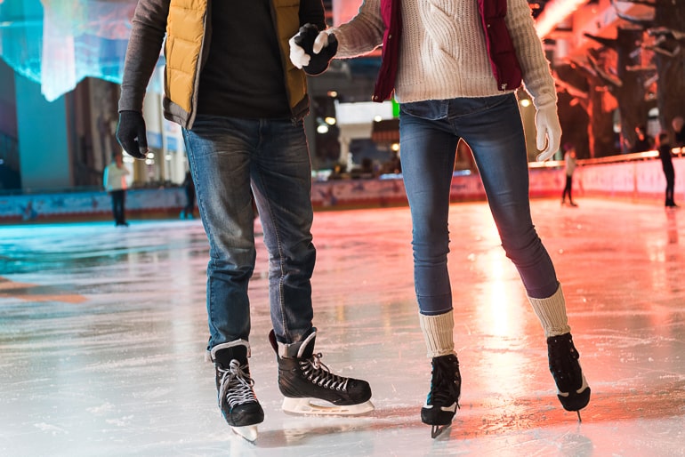 two people ice skating on ice rink