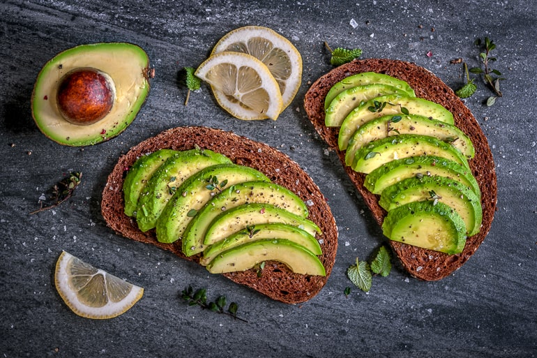 sliced avocado in dark rye bread