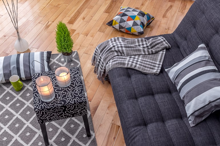 Couch with blankets and table with candles cope with moving away from loved ones