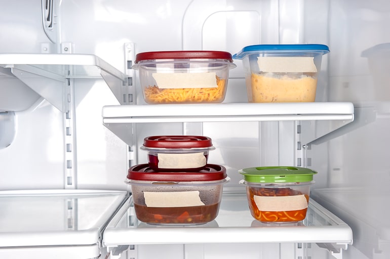 Tupperware containers with labels in fridge