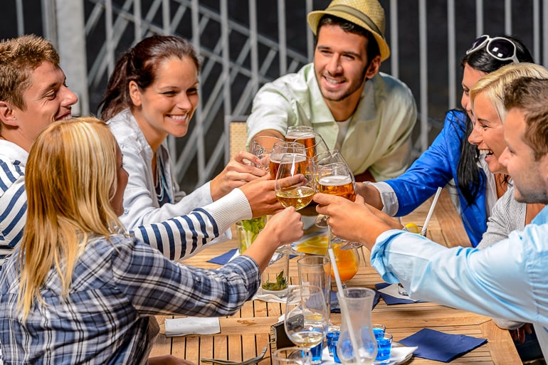 Group of friends raising glasses and laughing how to not lose yourself in relationship