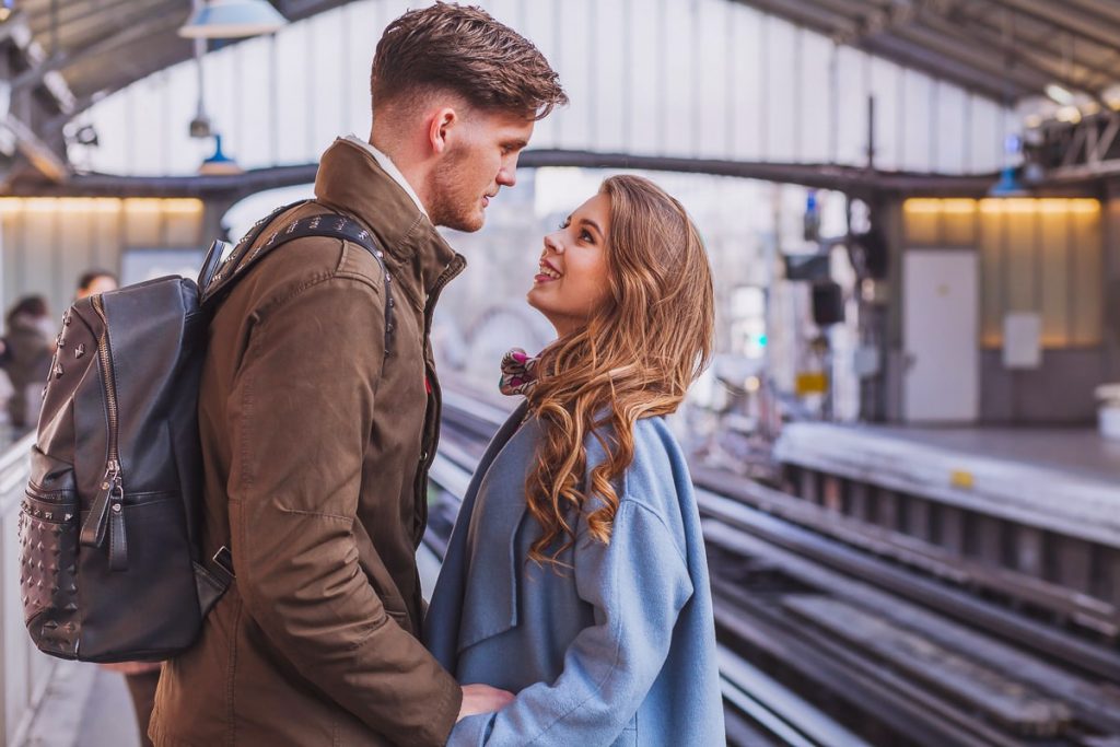 couple standing at train station saying goodbye how to survive a long distance relationship