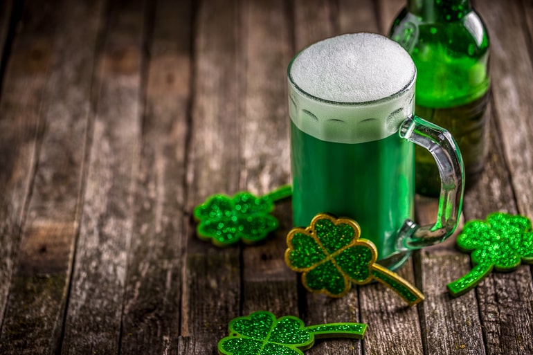 mug of green beer on wooden table for st patricks day