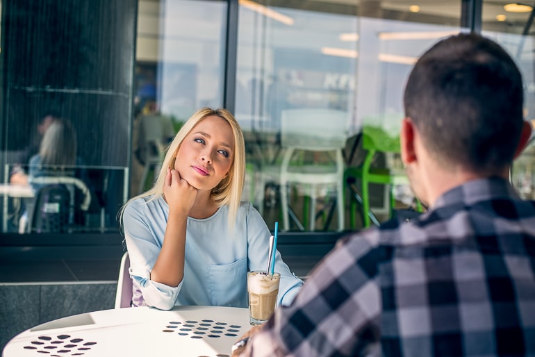 woman looking bored at table while man talks what not to do on a first date