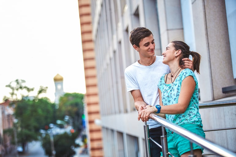 couple standing together on balcony