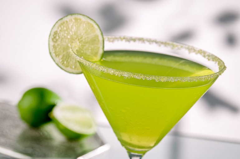 margarita in wide brimmed glass with salt and circle of lime