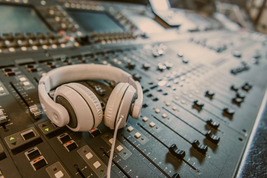 white headphones on mixing table