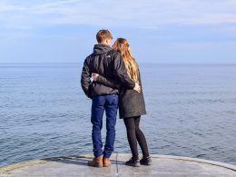 couple standing at waters edge on pier intercultural relationship