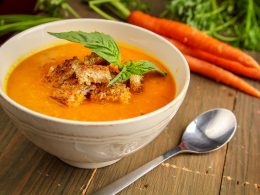 orange soup in bowl with spoon on table fall dinner ideas