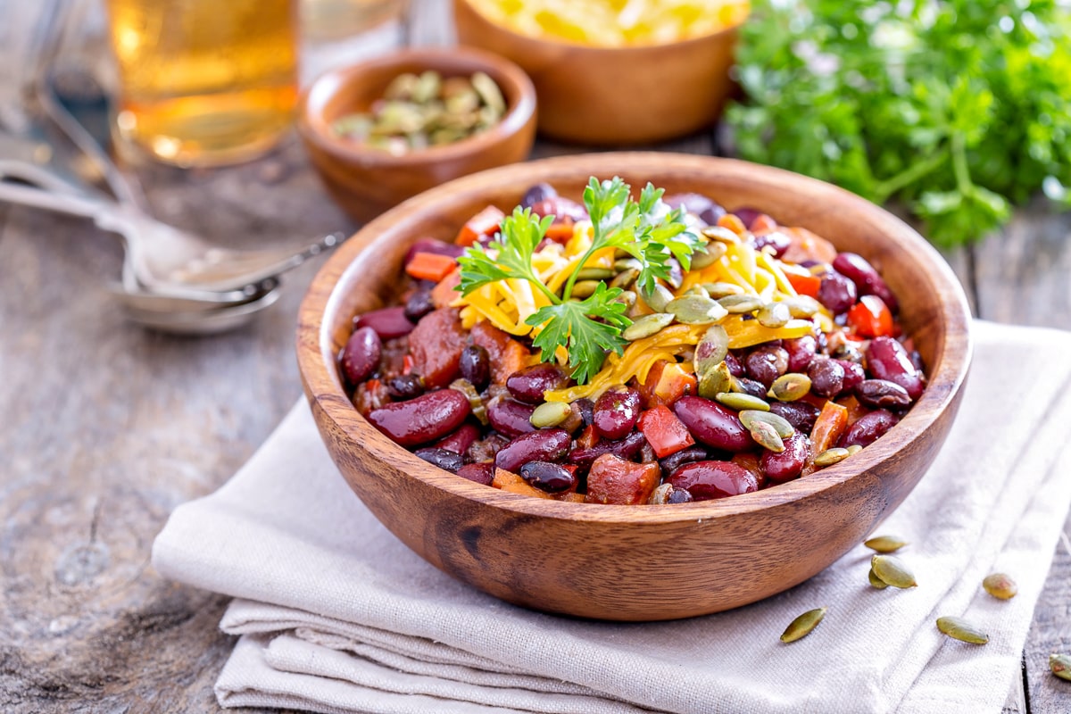 Stew with kidney beans in wooden bowl on table healthy meals on a budget