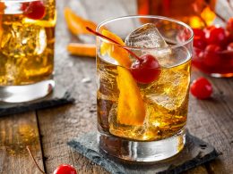 orange drink with ice and cherry in short glass best alcoholic drinks