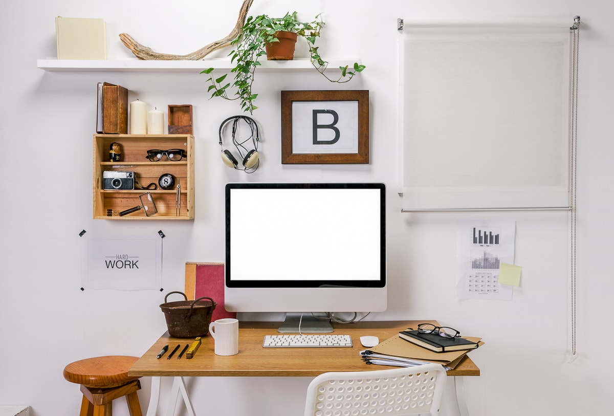 computer monitor on desk with decor around productivity improvement tools
